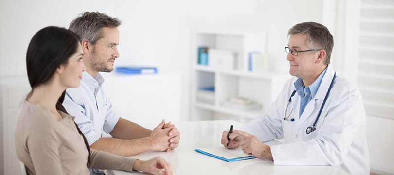 a man and a woman consult a doctor