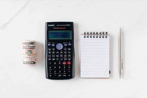money, calculator, notebook, and ball pen
