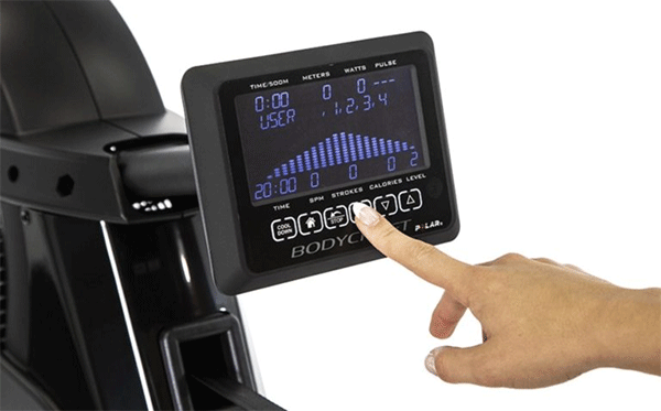 a finger pointing at the monitor of Bodycraft vr500 rowing machine