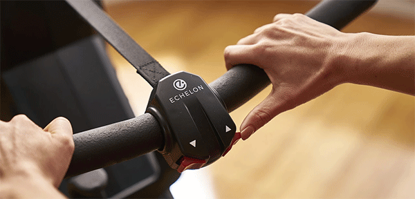 two hands gripping the handlebar and one finger pressing the resistance button on the right side of the handlebar of Echelon magnetic rowing machine