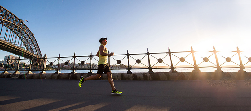 A person wearing a hat runs outdoor